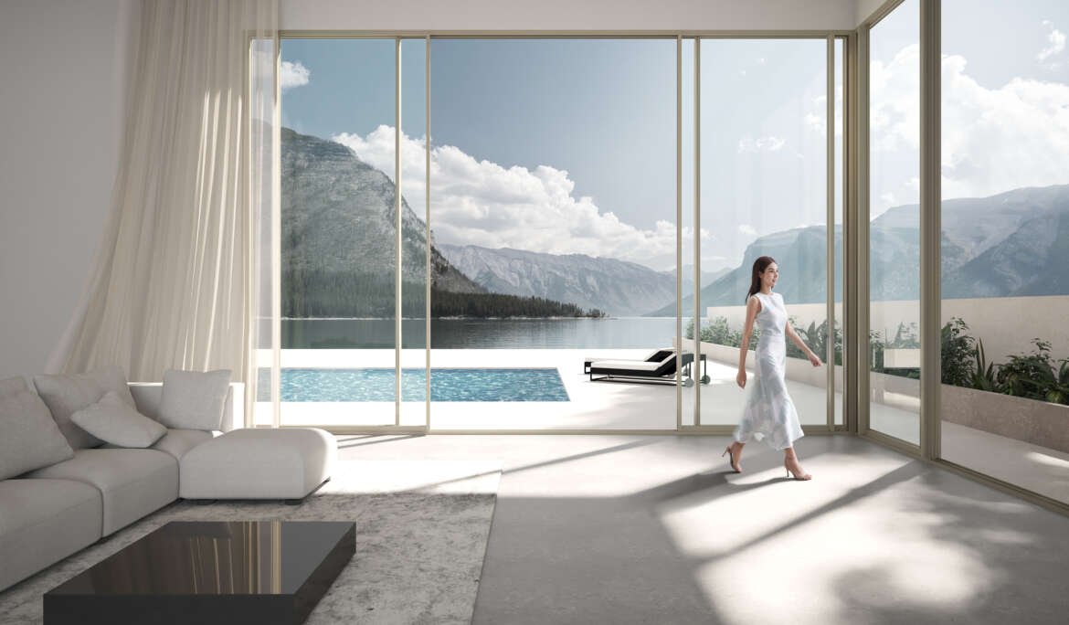 A modern living room with floor-to-ceiling aluminium sliding doors opening to a stunning mountain and lake view. A woman in a white dress walks gracefully through the open doors, emphasizing the seamless indoor-outdoor connection and elegance of the space.